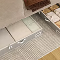 Under Bed White Storage Bins with Handles Holding Neatly Folded Clothes in Bedroom