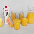 Orange Juice Carton With Glasses Pitcher And Fresh Orange Slices On Table