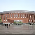 Contemporary Hospital Building With Curved Wooden Facade And Spacious Plaza Entrance