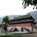 Ancient Chinese Architecture With Green Tiled Roof Overhanging Eaves And Stone Steps