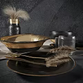 Black Gold Dinnerware Set With Plates Bowls Cups Glassware Feather Decor On Gray Textured Background