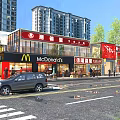 Busy Commercial Street With McDonald's Retail Stores High Rise Buildings Trees Vehicles And Pedestrians