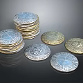 Intricately Sculpted Silver And Gold Coins With Detailed Carved Designs Stacked And Scattered