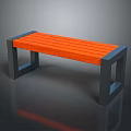 Outdoor Park Bench With Orange Wooden Slats And Gray Metal Frame In Natural Setting