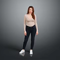 Woman in beige long sleeve top and dark jeans with white sneakers against gray background
