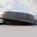 Modern Curved Museum Building With Metal Facade And Large Glass Windows Against Open Sky Background
