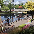 Waterfront Landscape With Wooden Boardwalk Curved Paths People Walking And Lakeside Green Trees