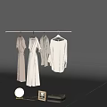 Collection of White and Light Clothes Hanging on Hangers with Decorative Mirror Frame and Towel