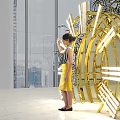 Giant Clock Art Installation With Illuminated Roman Numerals And People Interacting