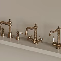 Three Classic Brass Faucets Arranged On Light Countertop With Elegant Handles