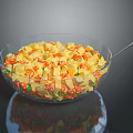 Fresh Salad in Transparent Glass Bowl with Diced Colorful Vegetables and Spoon on Tabletop