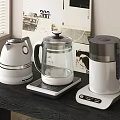 Modern Household Appliances Three Stylish White Glass Kettles On Wooden Table
