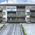 Multi Story Residential Building With Colorful Balconies Stone Pavement And Plants