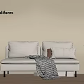 Poliform White Sofa Bed With Pillows Checked Blanket And Potted Plant On Wooden Floor