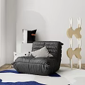 Cozy Black Bean Bag Chair In Modern Living Space With Soft Pillows And Decorative Wooden Rack