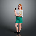 Red Haired Woman In White T-Shirt With Colorful Graphic Green Skirt And Black Shoes Holding Smartphone
