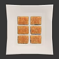 Layered Square Pastries with Golden Crust and Red White Layers on White Square Plate
