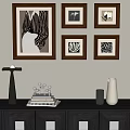 Framed Abstract Paintings on Wall with Decorative Vase Candle Holder and Book Stack 3d model