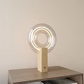Modern Minimalist Table Lamp With Transparent Circular Shade And Wooden Base On Wooden Table