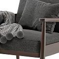 Cozy Gray Armchair With Wooden Frame Pillows And Pom Pom Blanket