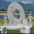 Scenic Garden Landscape With White Floral Archway Circular Ornament Pillars Lawn Lake And Mountain Backdrop