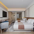 Modern Hotel Guest Room Interior With Double Bed Flat Screen TV Desk And Chair