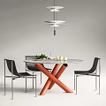 Modern Round Dining Table Set With Orange Legs And Black Chairs With Silver Metal Legs