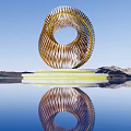 Spiral Golden Striped Sculpture With White Base And Water Reflection Against Blue Sky Mountain Backdrop