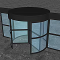 Circular Revolving Door With Black Frame And Glass Panels On Gray Floor