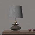 Wooden Base Table Lamp With Beige Lampshade And Two Red Fruits On Wooden Table