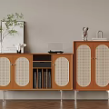Wooden Cabinet With Rattan Doors Books And Decorative Items On Top
