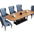 Elegant Oval Wooden Dining Table With Blue Tufted Chairs White Candle Holders And Black Bowl