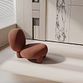 Modern Brown Fabric Leisure Chair In Bright Living Room With Bookshelf And Marble Wall