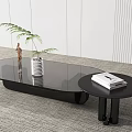 Modern Black Coffee Table With Glass Top And Side Table Decorated With Plant Books Statue
