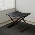 Wooden Cross Leg Folding Stool With Black Leather Seat In Minimalist Interior