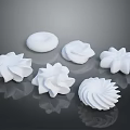 White Whipped Cream Dessert Decorations With Various Flower Spiral And Round Shapes On Black Background