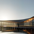 Modern Sales Office Building With Curved Roof Glass Curtain Wall Water Pool Reflection And Sunset