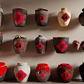 Traditional Ceramic Vessels With Various Colors And Fu Character Labels On Wall And Shelf