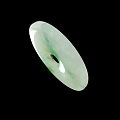 Round Green And White Jade Pendant With Central Black Hole On Black Background