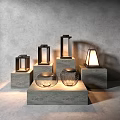 Modern Outdoor Lights With Metal Frames And Glass Shades On Concrete Pedestals