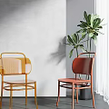 Stylish Yellow Red Dining Chairs With Mesh Backs Near Gray Wall Green Plant And Window