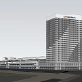 Large Modern Building Complex Featuring High Rise Tower Glass Facade With Surrounding Roads And Greenery