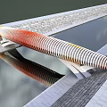 Scenic Modern Landscape Bridge With Orange White Striped Design Spanning Water And Reflection