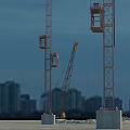 Yellow Functional Construction Vehicle On Sandy Ground With Two Tall Tower Cranes And Urban Buildings