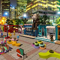 Modern Container Building in Urban Night Scene with Colorful Decorations and Green Plants