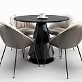 Modern Round Black Table With Four Light Gray Leather Chairs And White Cup