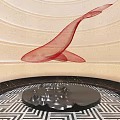 Silver Sculpture Carving On Black Circular Base With Beige Wall Curved Lines And Red Mesh Ribbon