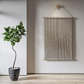 Woven Textured Wall Decor on White Wall with Green Leaf Plant in Gray Pot