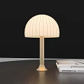 Dome Shaped Table Lamp With White Vertical Striped Lampshade And Golden Base On Desk