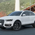 White Audi SUV Parked On Road With Mountains Trees And Red Flowers